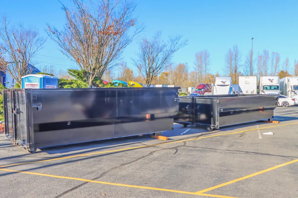 Professional dumpster rental service with roll-off container on residential driveway in Omaha